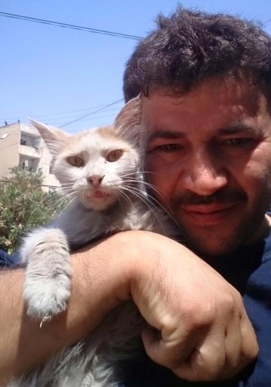 mohammad holding cute white cat