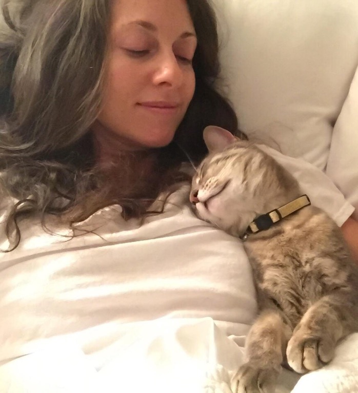 cat cuddling with mom